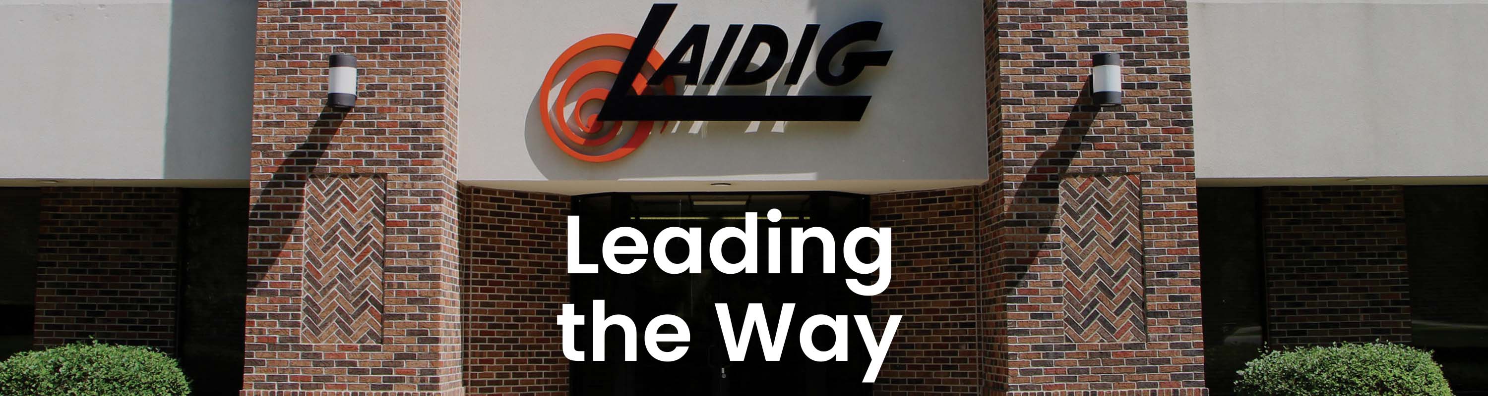 Image showing Laidig headquarters with white text overlay that reads LEADING THE WAY bulk material handling system, bridging, rat-holing, material flow, reclaim, reclaimer, silo unloading, unloader, bulk material storage, reclaim system, dry bulk unloading, grain unloading