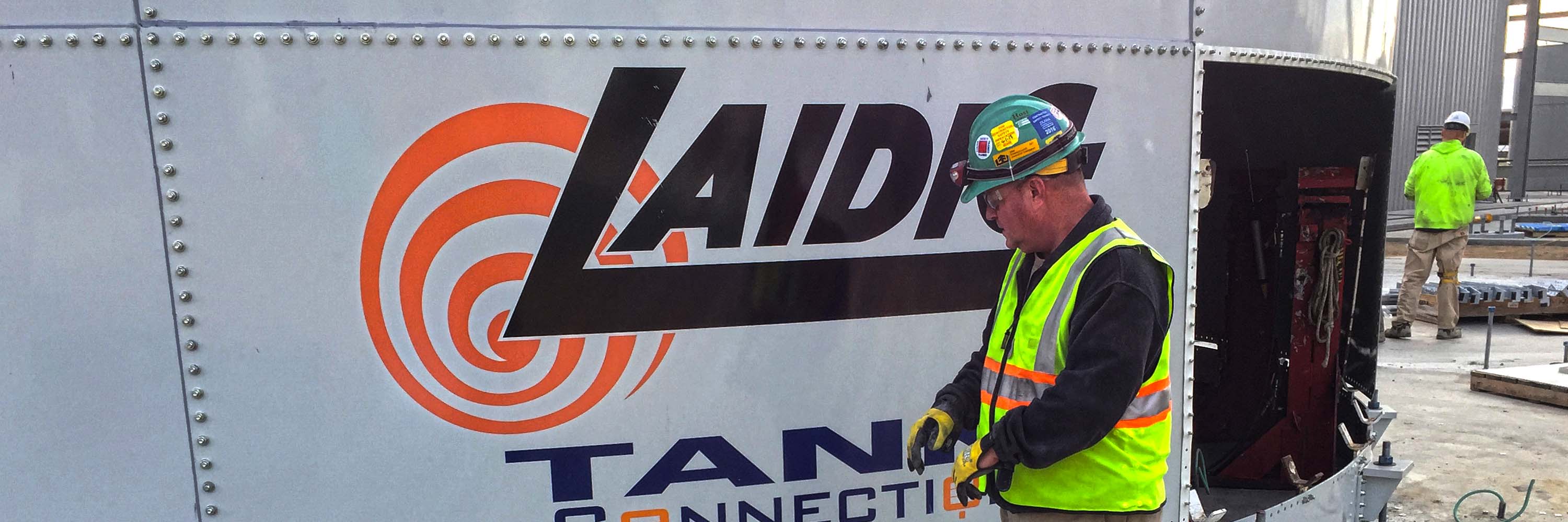 Laidig employee inspecting silo exterior bulk material handling system, bridging, rat-holing, material flow, reclaim, reclaimer, silo unloading, unloader, bulk material storage, reclaim system, dry bulk unloading, grain unloading