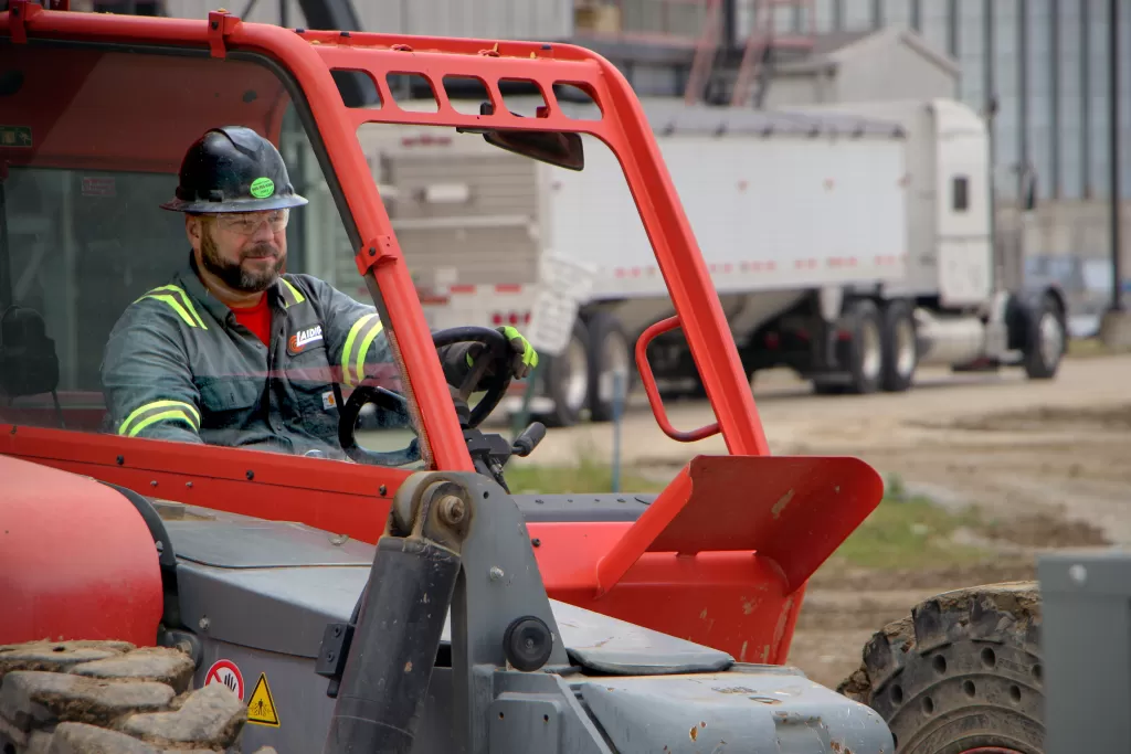 Laidig Field Service Technician finishing up installation on Laidig cone-bottom reclaimer bulk material handling system, bridging, rat-holing, material flow, reclaim, reclaimer, silo unloading, unloader, bulk material storage, reclaim system, dry bulk unloading, grain unloading